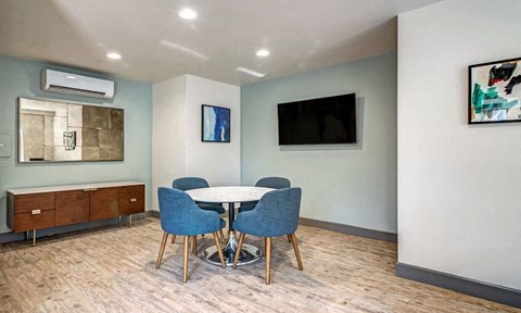a dining room with a table and chairs and a television