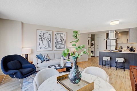 a living room and kitchen with a table and chairs