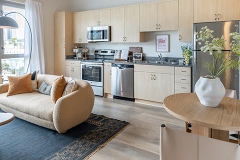 A modern kitchen with a sofa and a table.