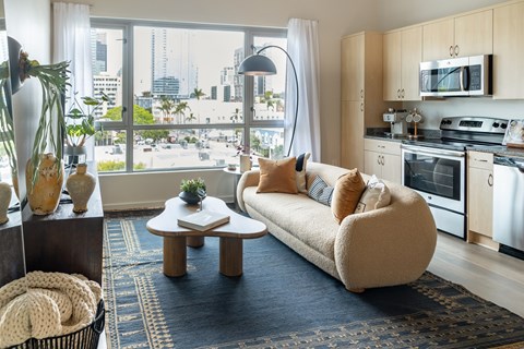 A modern living room with a large window overlooking the city.