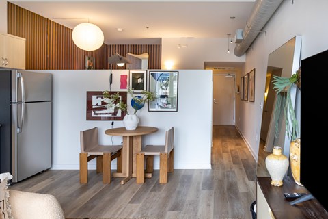 A modern kitchen with a dining table and chairs.