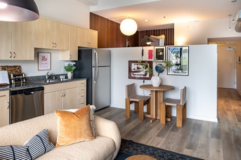A modern kitchen with a dining table and chairs.
