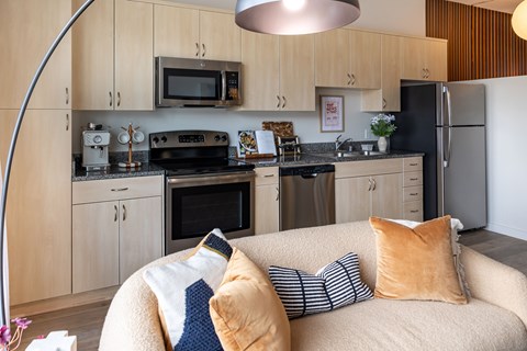 A modern kitchen with a couch in front of it.