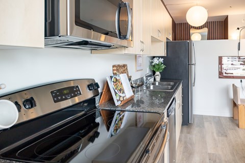 A modern kitchen with a black stove top oven and a black refrigerator.