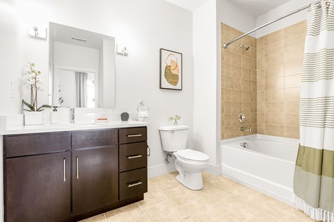 A bathroom with a toilet, sink, and bathtub.