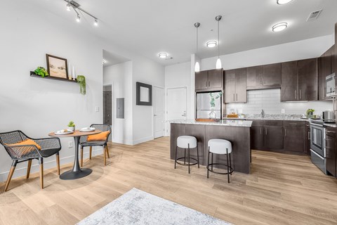 A modern kitchen with a dining table and chairs.