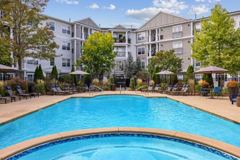 A swimming pool in front of apartment buildings.
