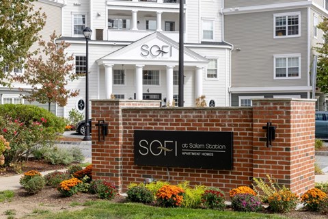 The image shows a building with a sign that reads "SOFI at Salem Station Apartment Homes".