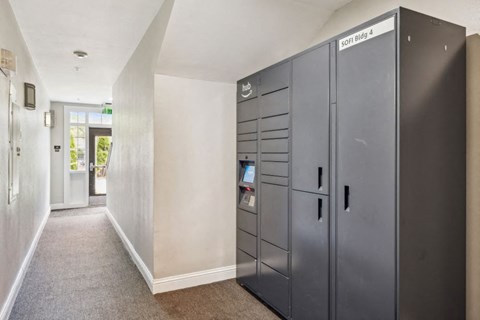 A hallway with a locker on the right and a door on the left.