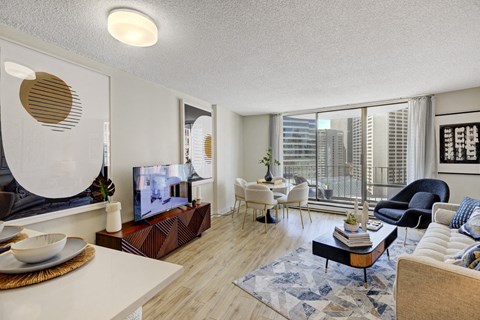 a living room with a large window and a city view