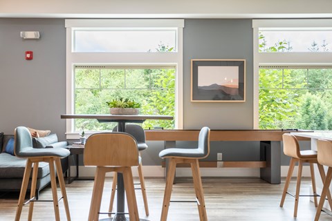 a living room with stools and a table with chairs