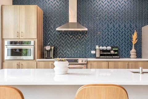 a kitchen with a white counter top and a microwave