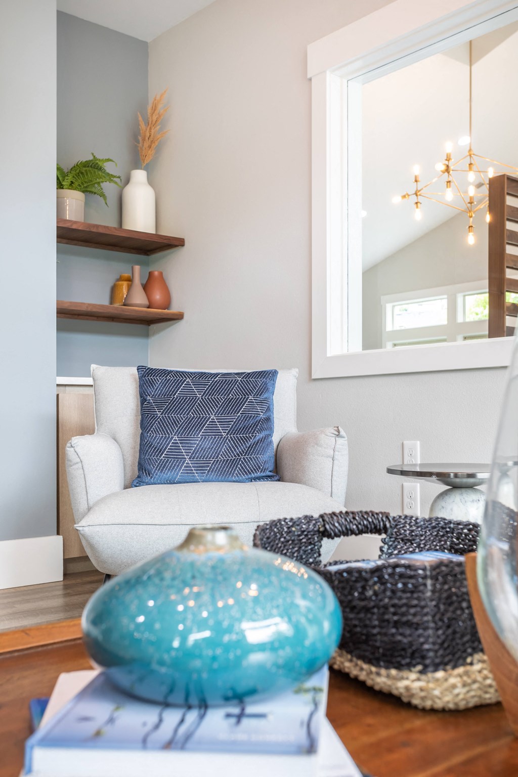 a living room with a white couch and blue pillows