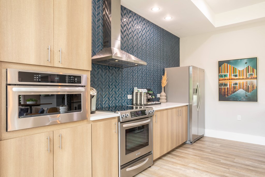 a kitchen with wooden cabinets and stainless steel appliances