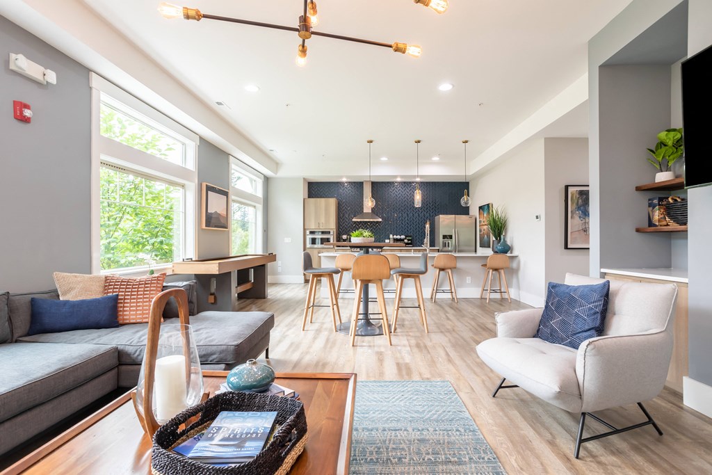 a living room with a couch and a kitchen with a table and chairs
