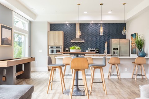 a kitchen with a large island with bar stools