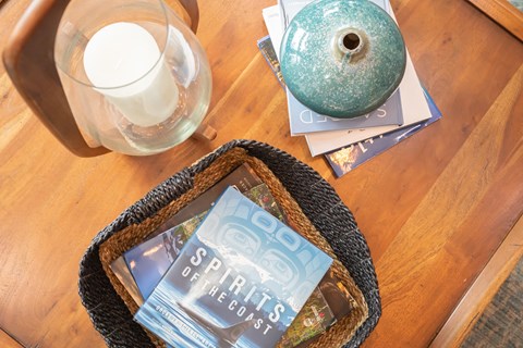 a basket of books and a glass of milk on a table