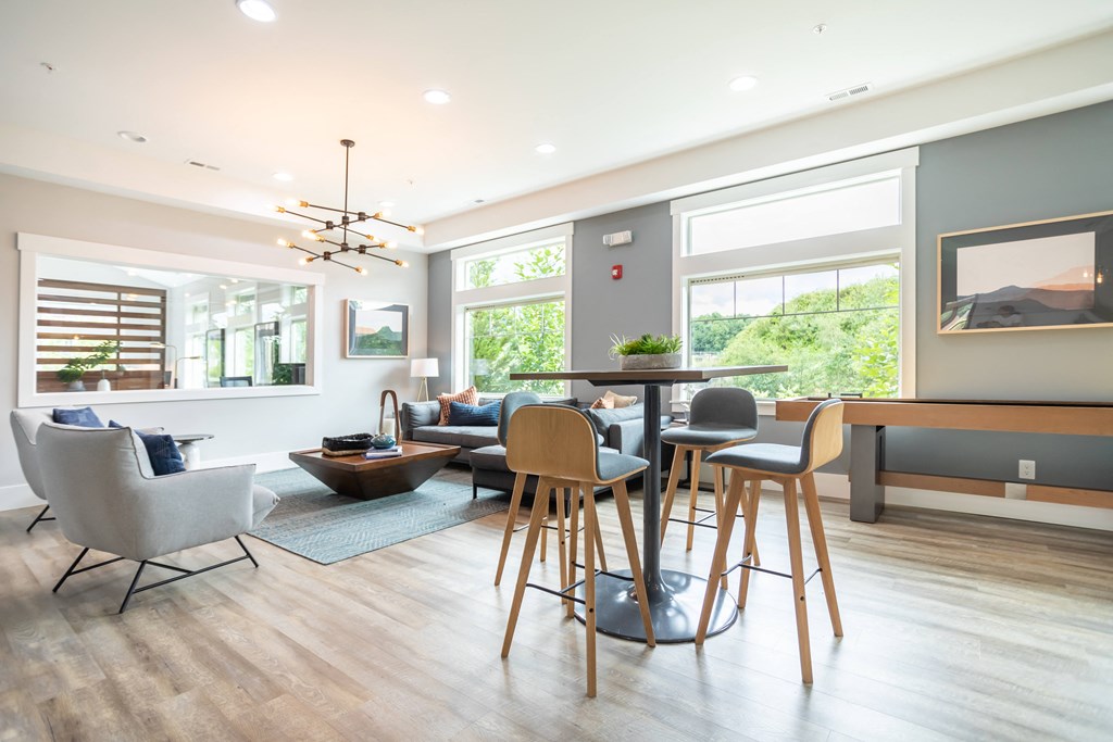 a living room with a dining room table and chairs
