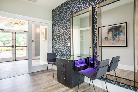 a dining room with a table and chairs and a large mirror