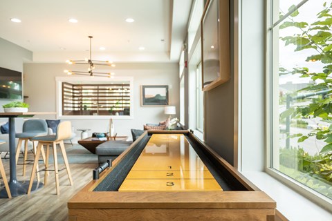 a ping pong table in the middle of a living room with a dining room