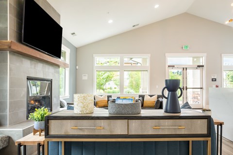 a living room with a fireplace and a table with a couch and a television