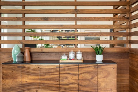 a counter in a room with a wooden wall and a window