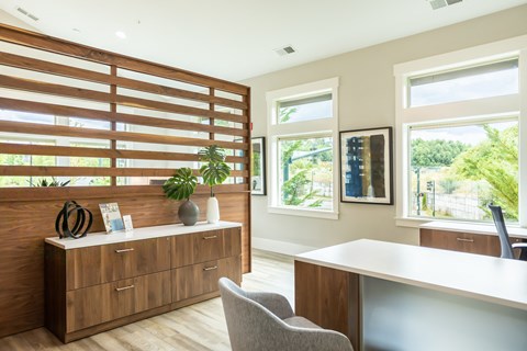 a home office with a desk and a window