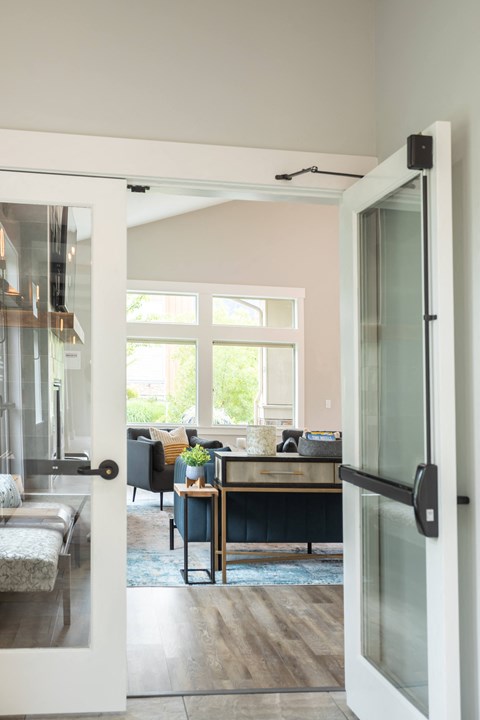 a view into the living room from the glass door of a home office