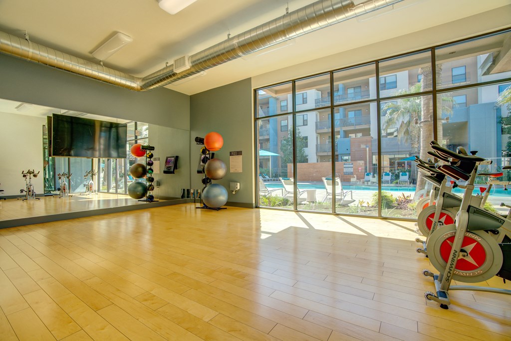 a workout room with a large window and a bike in it
