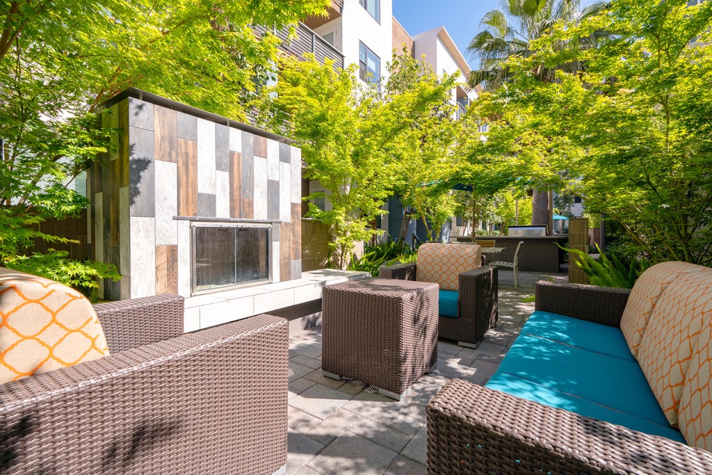 a patio with wicker furniture and a pool