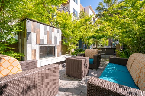 a patio with wicker furniture and a pool