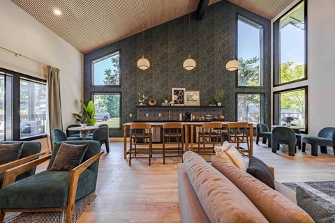 A living room with a long couch and a wooden table.