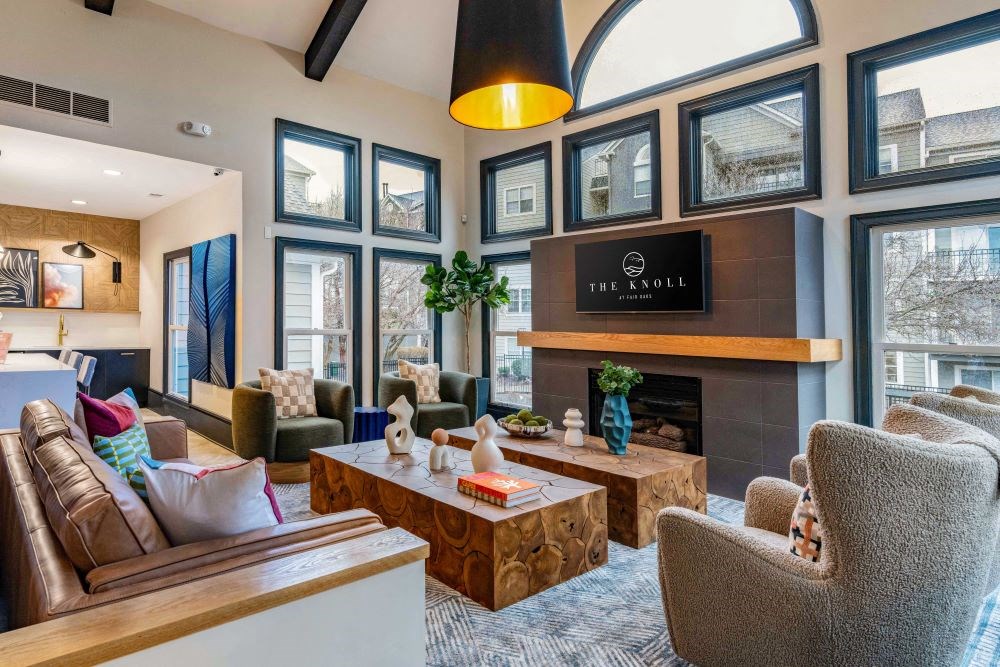 A living room with a fireplace and a sign that says "The Enroll".