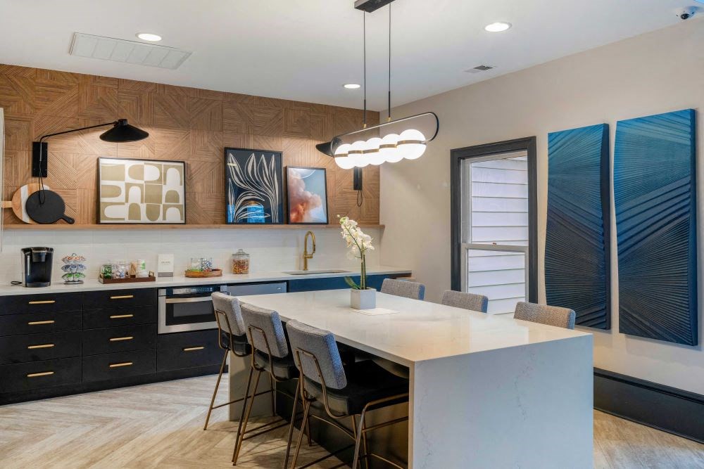 A modern kitchen with a large island and bar stools.