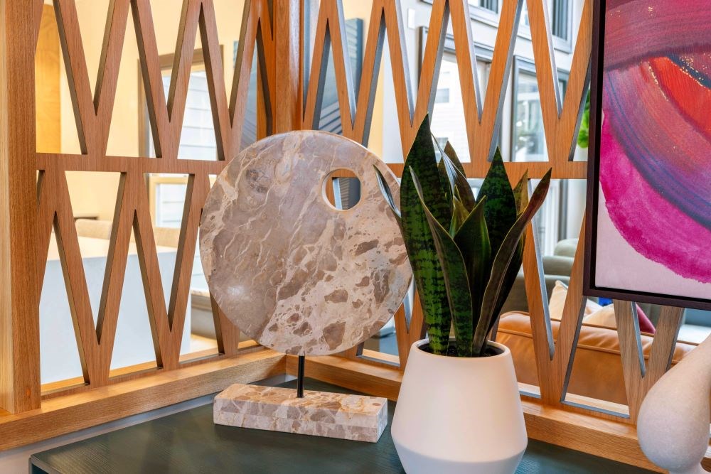 A stone sculpture with a hole in the middle sits on a table.