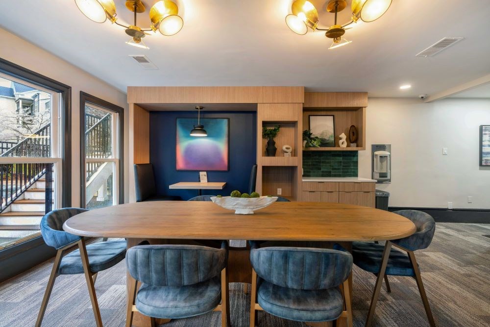 A dining room with a wooden table and blue chairs.