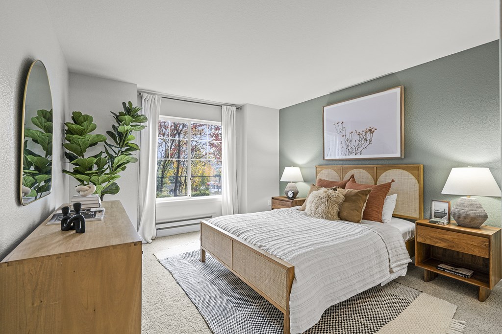 a bedroom with a bed and a window