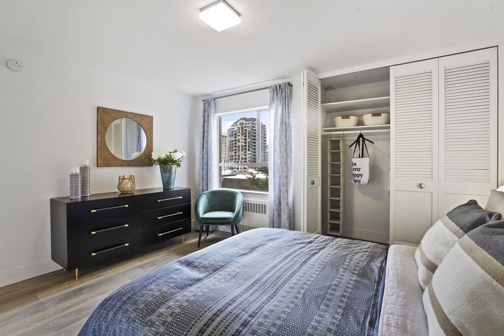 a bedroom with a bed and a dresser and a window