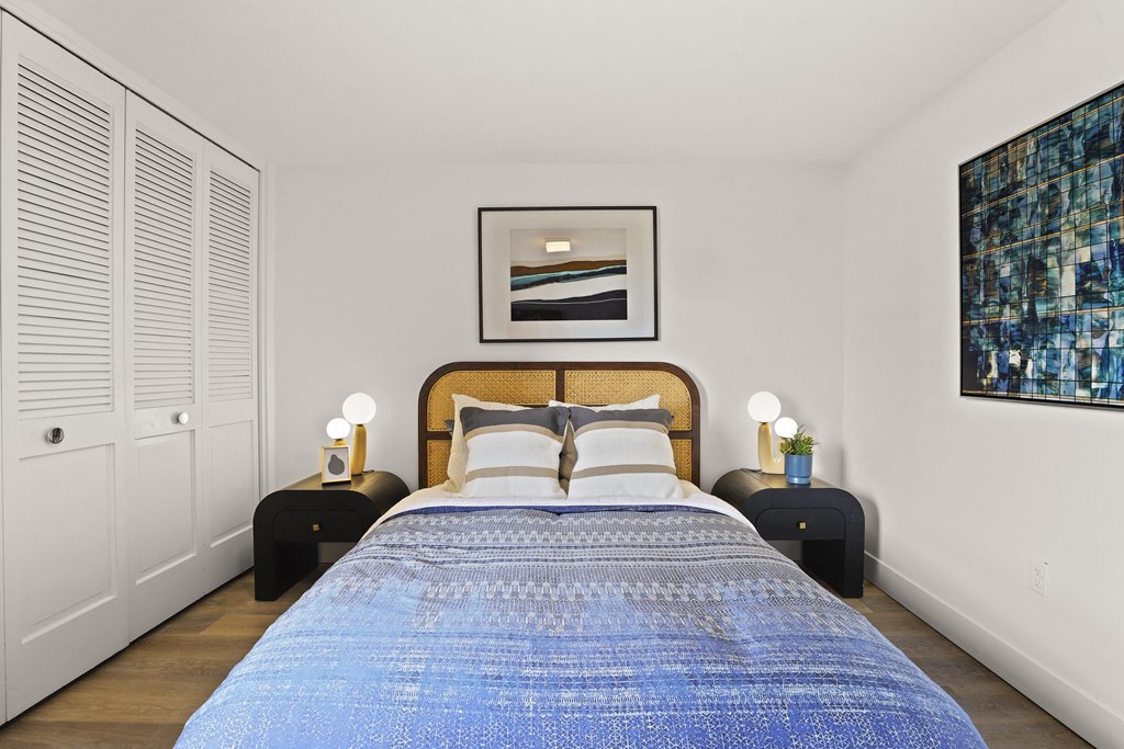 a bedroom with a large bed and a blue blanket