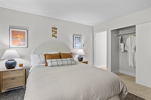 a bedroom with a large bed and a closet