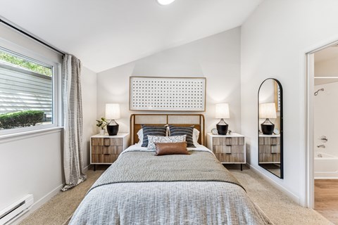 a bedroom with a bed and a large window