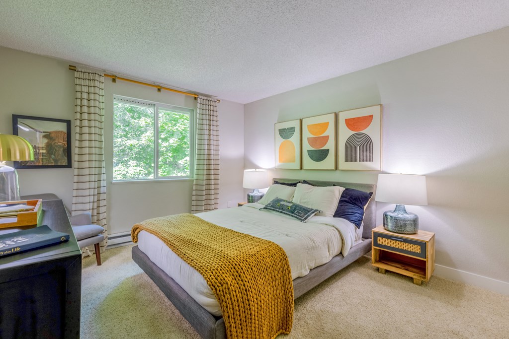 a bedroom with a large bed and a window