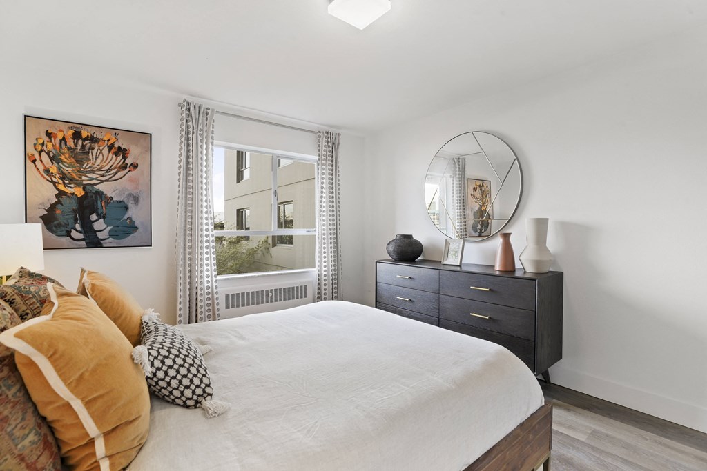 a bedroom with a large bed and a mirror