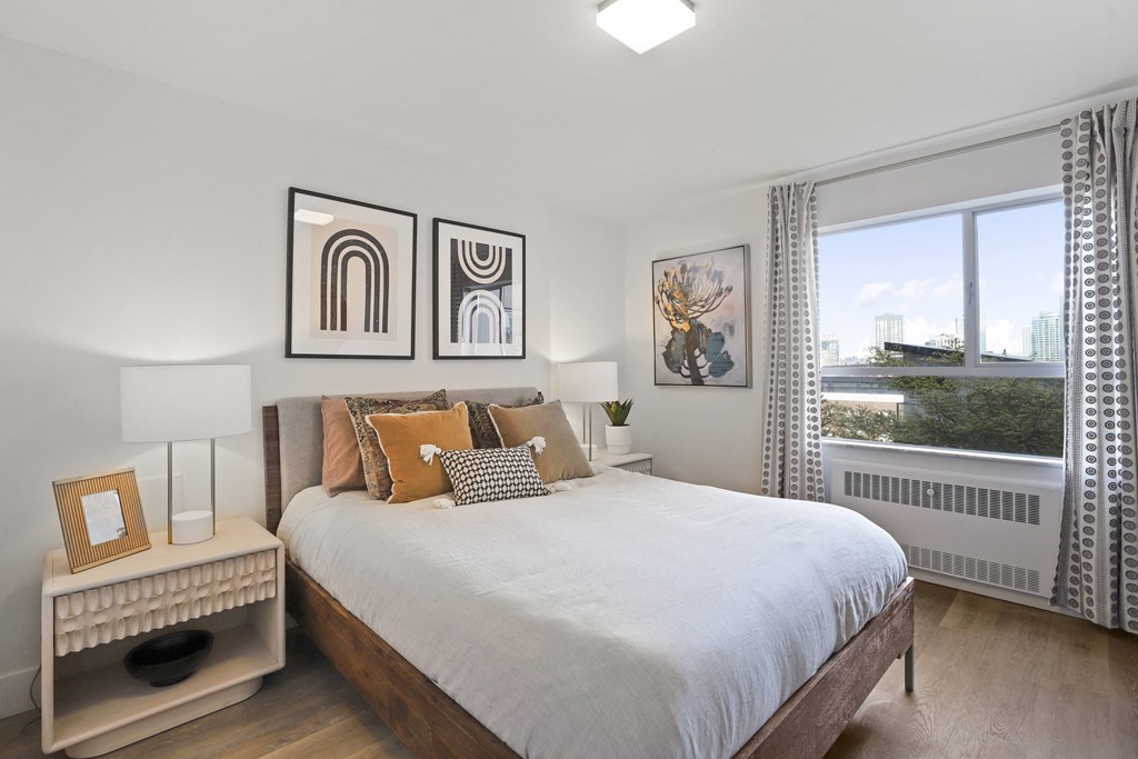 a bedroom with a large bed and a window