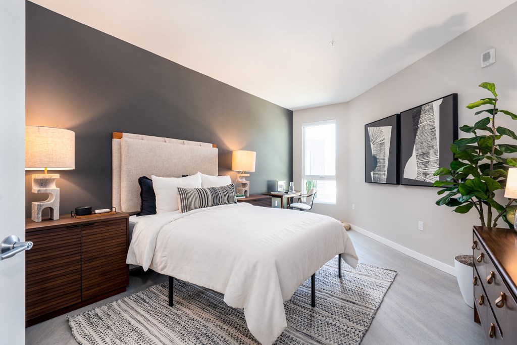 a bedroom with a large bed and a window