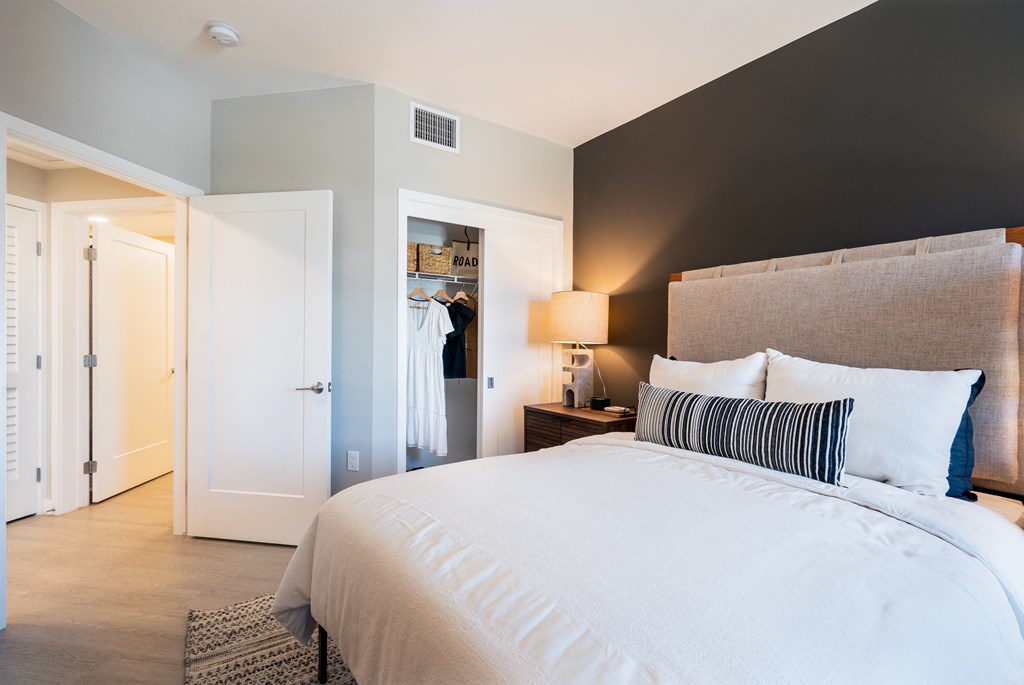 a bedroom with a large bed and a closet