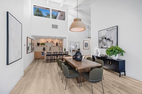 A modern dining room with a wooden table and chairs.