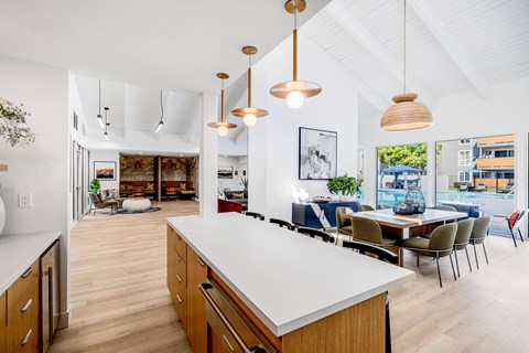 A modern kitchen with wooden cabinets and a white countertop.
