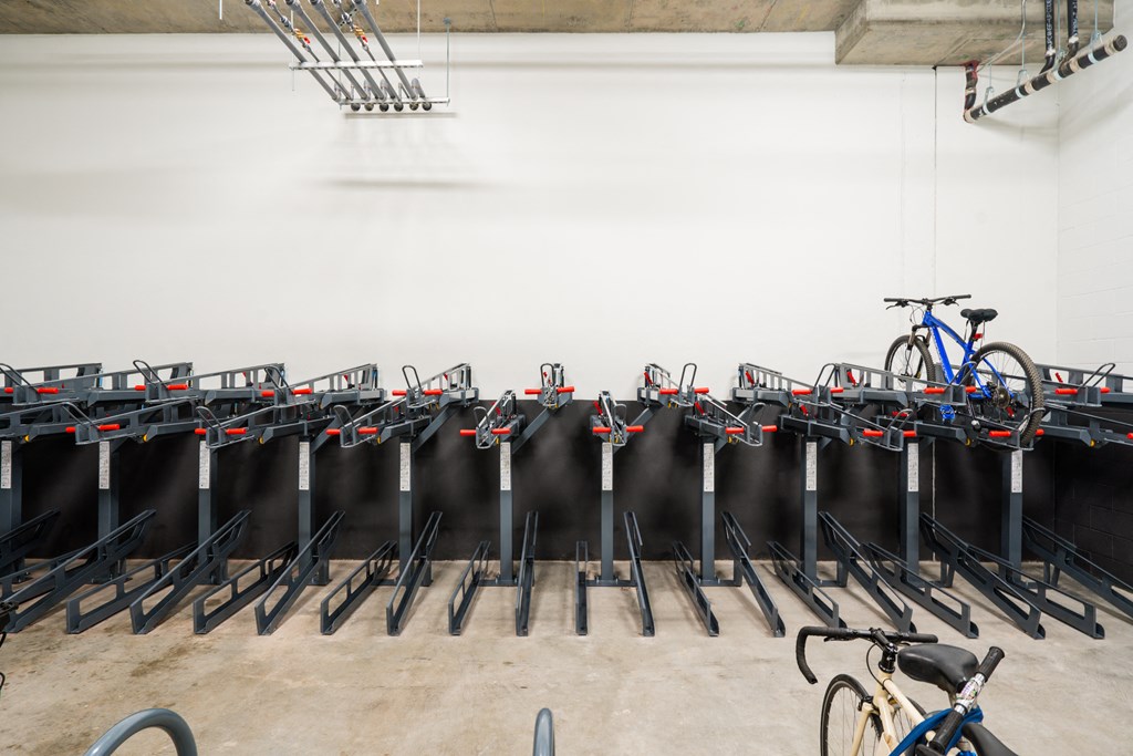 a row of bike racks in a room with bikes on them