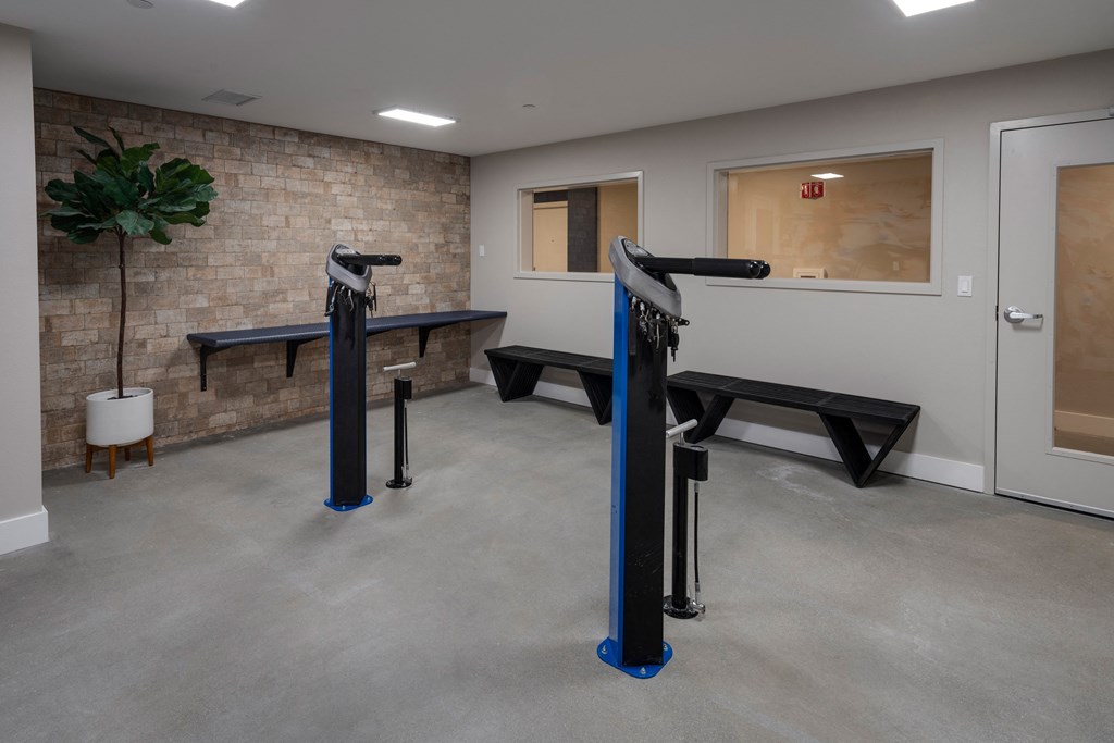 a fitness room with benches and exercise equipment in a building